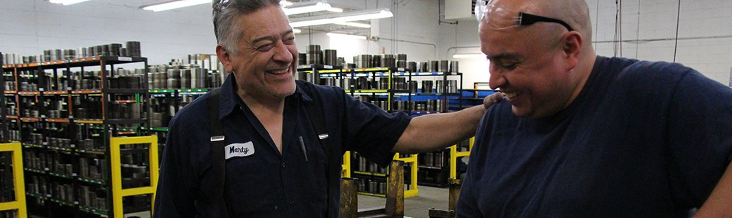 Close-up of Marty and co-worker smiling and laughing, hand on shoulder