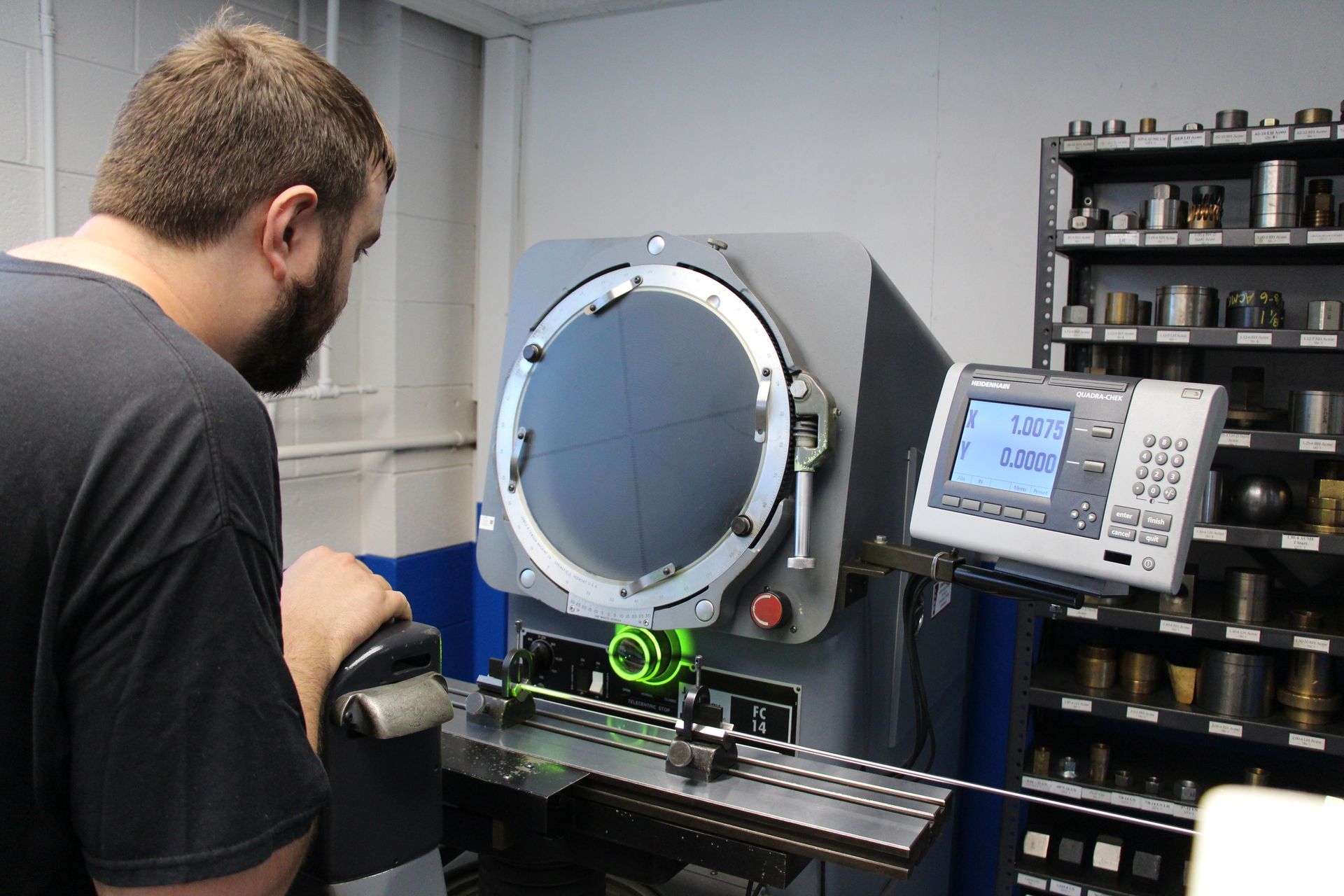 Rolled Threads employee quality checking measurements on a rolled thread part