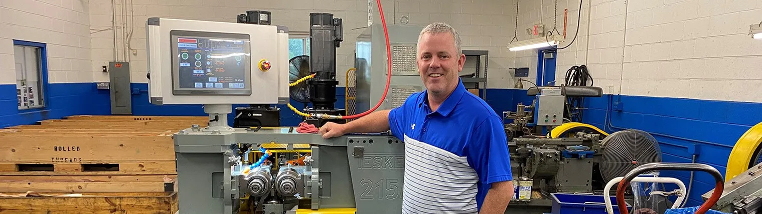 Matt Ladky standing next to a Teske 215 thread roller