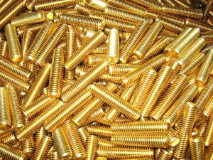 pile of gold threaded studs
