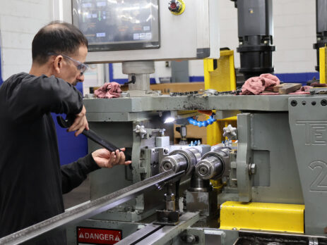 skilled operator working on an partially automated thread rolling machine