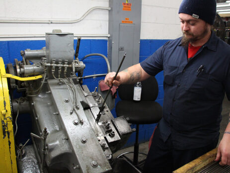 employee working on a machine - manufacturing month