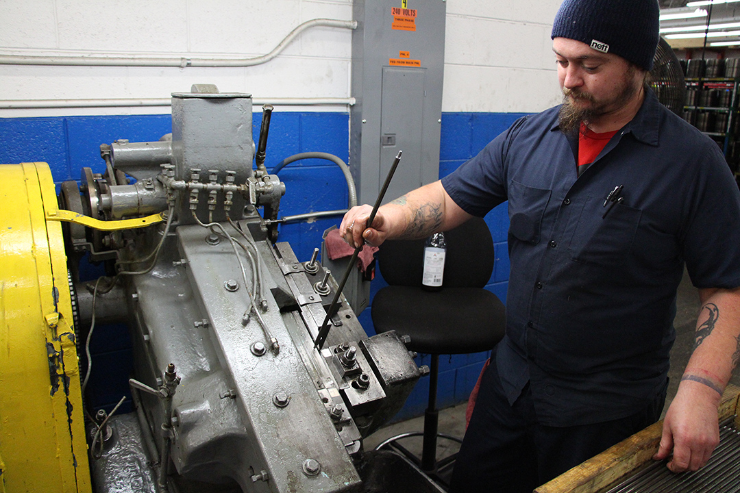employee working on a machine - manufacturing month